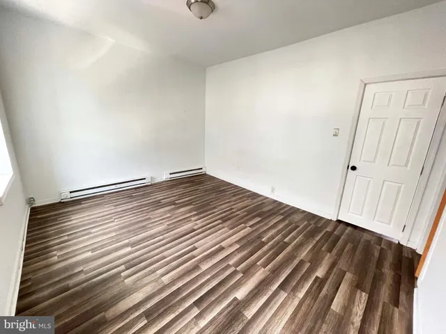 a view of room with wooden floor