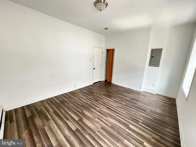an empty room with wooden floor
