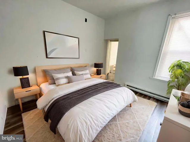 a bedroom with bed and a window