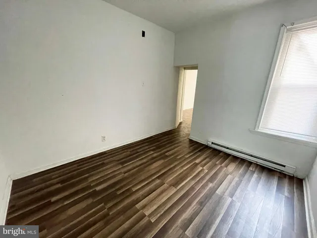 a view of an empty room and a window
