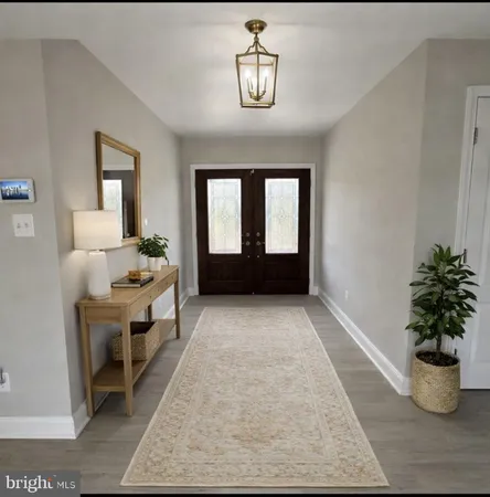 a living room with furniture and potted plant