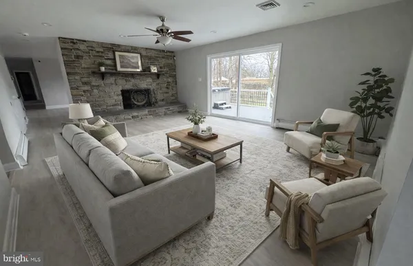 a living room with furniture and a fireplace