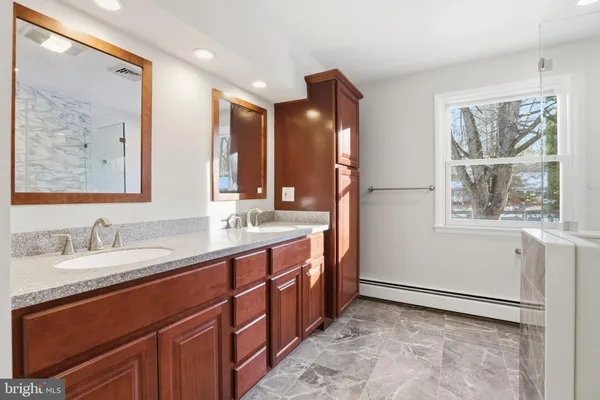 a spacious bathroom with a double vanity sink and a mirror