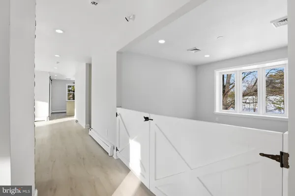 a view of a hallway with wooden floor