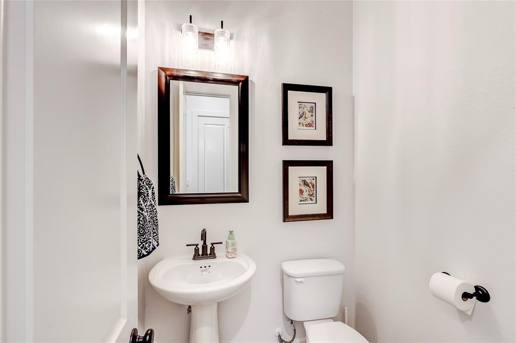126 LITTLE Strm Cove Austin, TX 78737 - Photo 21 of 40 A compact powder room with a sleek pedestal sink and contemporary framed mirror.