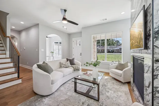 a dining room with furniture a chandelier and wooden floor