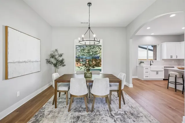 a kitchen with a sink stove and wooden floor