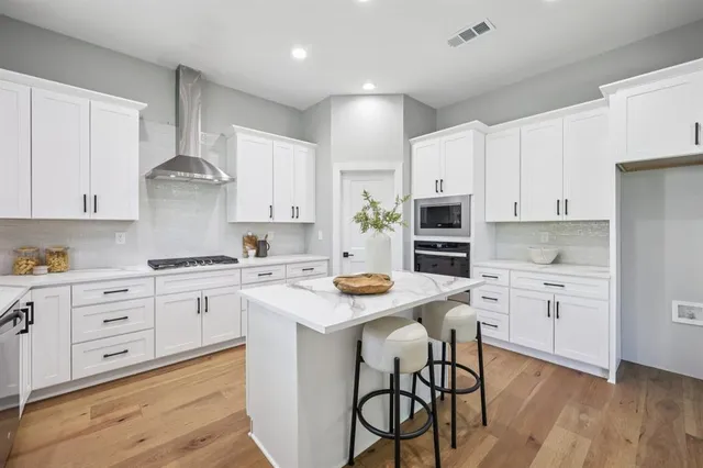 a vase of flowers sitting on a table with a potted plant