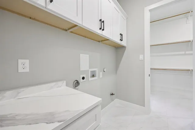 a view of a house with a wooden door and a yard