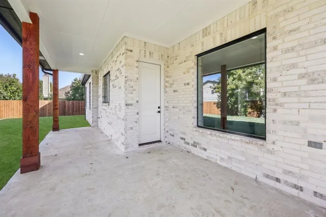 an aerial view of a house with garden space and street view
