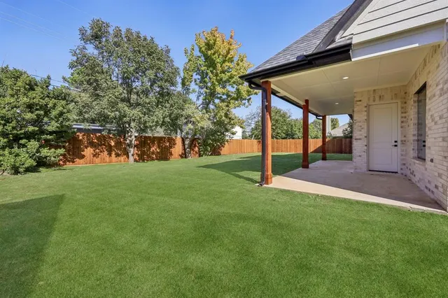an aerial view of a house with a garden and a yard