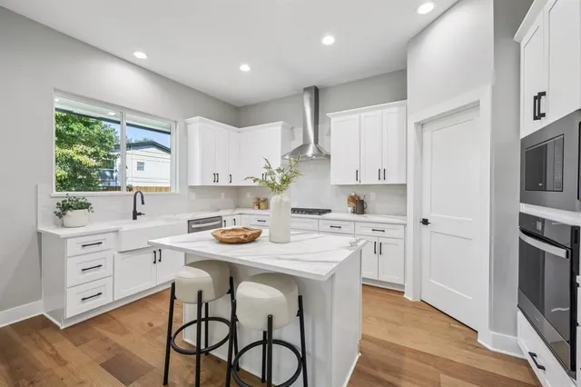 a kitchen with white cabinets stove and refrigerator