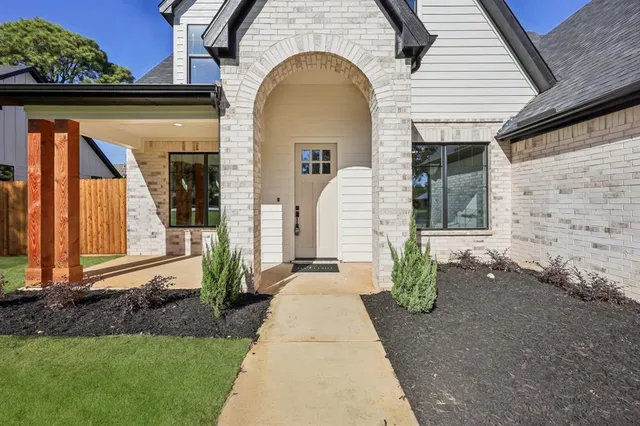 a view of a bedroom with a bed and wooden floor