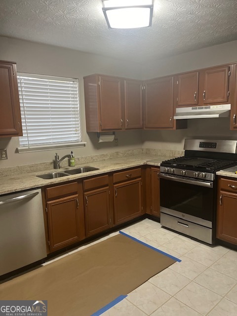 2635 Ashley Downs Lane South Fulton, GA 30349 - Photo 12 of 12 a kitchen with granite countertop a stove a sink and dishwasher wooden cabinets