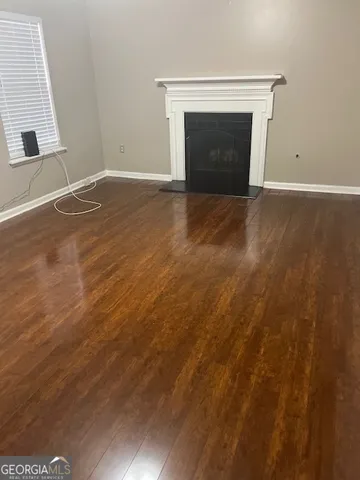 a view of empty room with a fireplace
