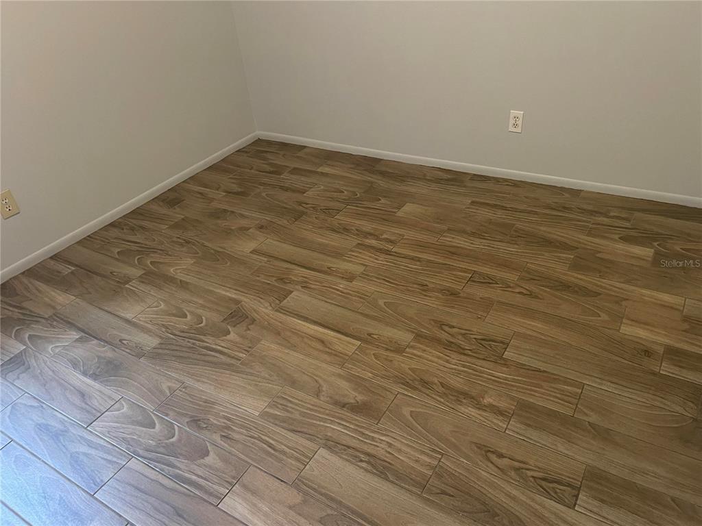 179 Margie Street Palm Harbor, FL 34683 - Photo 4 of 12 wooden floor in empty room