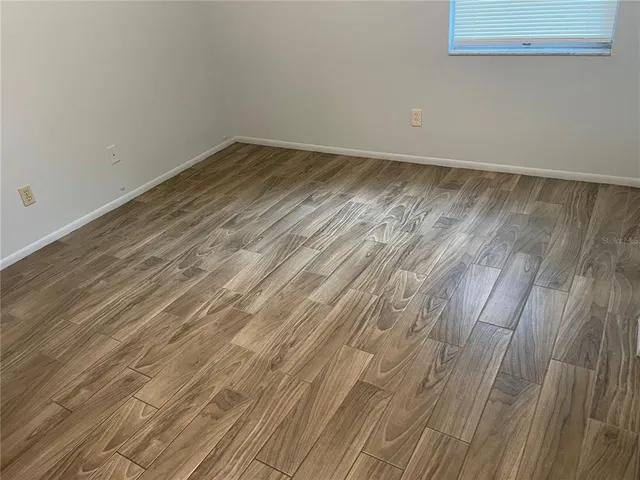 a view of a room with wooden floor