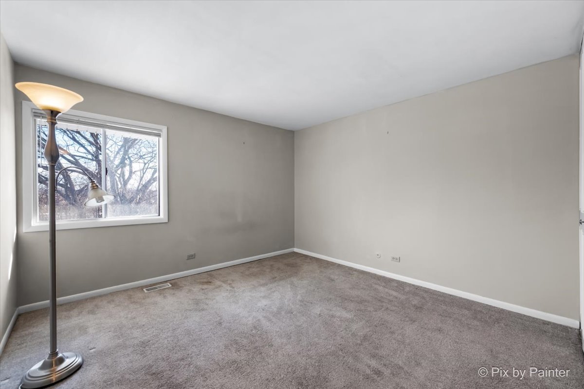 6207 Kit Carson Drive, Unit 6207 Hanover Park, IL 60133 - Photo 14 of 24 an empty room with windows