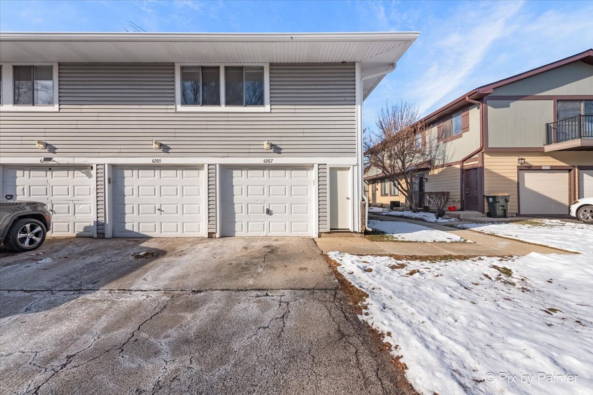 6207 Kit Carson Drive, Unit 6207 Hanover Park, IL 60133 - Photo 18 of 24 a view of a house with a snow on the road