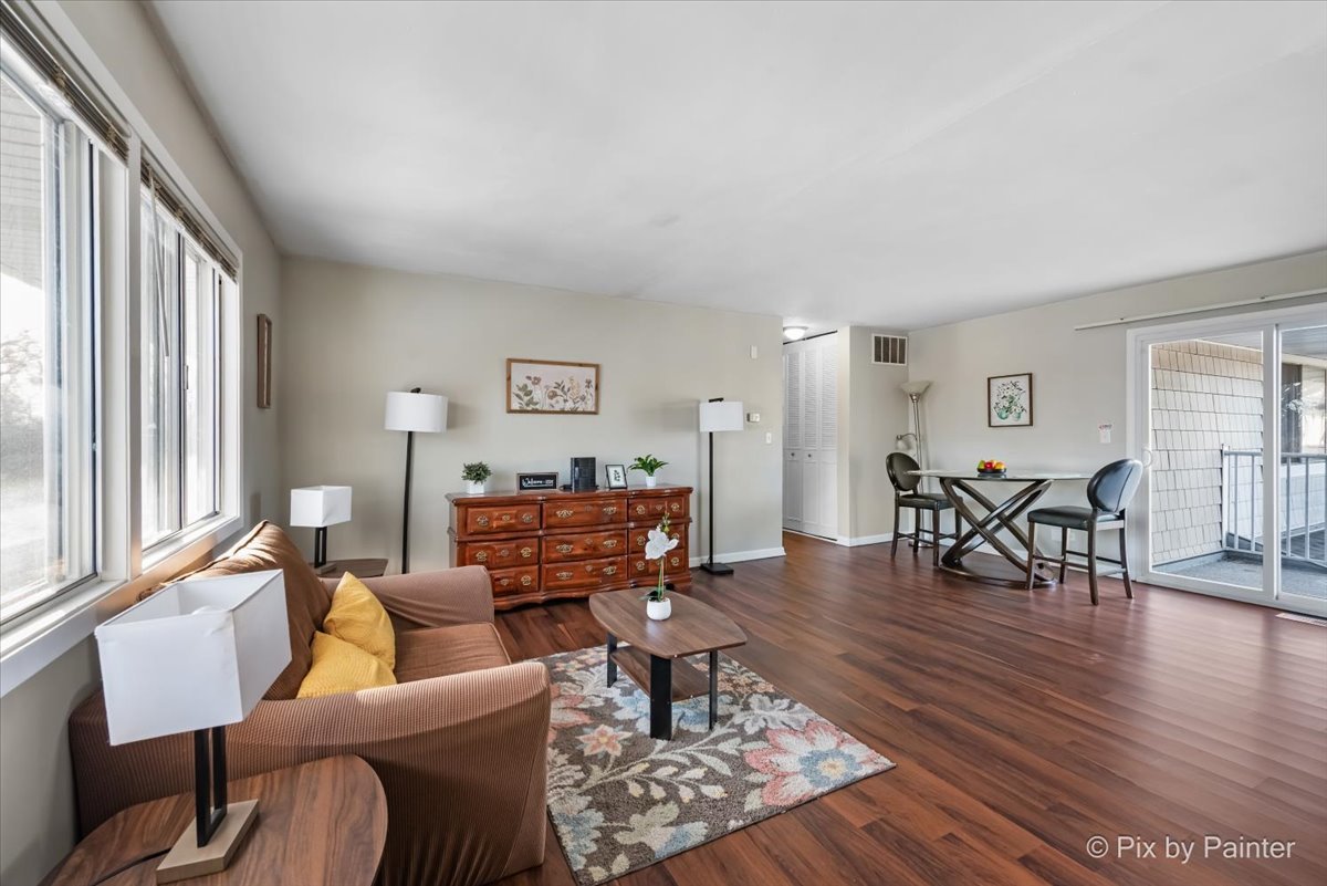 6207 Kit Carson Drive, Unit 6207 Hanover Park, IL 60133 - Photo 2 of 24 a living room with furniture and wooden floor
