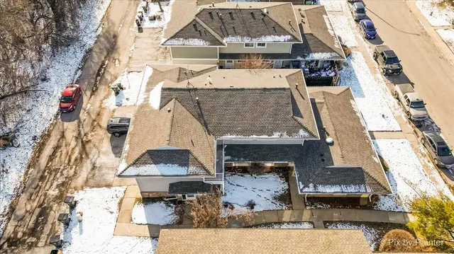 an aerial view of a house with a yard
