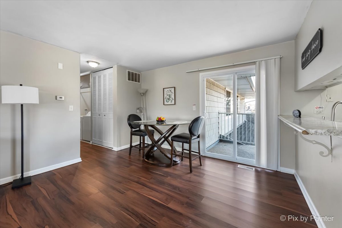 6207 Kit Carson Drive, Unit 6207 Hanover Park, IL 60133 - Photo 3 of 24 a view of a a dining room with furniture window and wooden floor