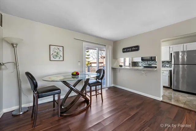 a dining room with furniture and wooden floor