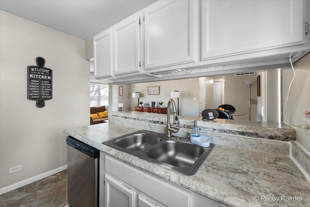 6207 Kit Carson Drive, Unit 6207 Hanover Park, IL 60133 - Photo 8 of 24 a kitchen with granite countertop a sink and a granite counter tops