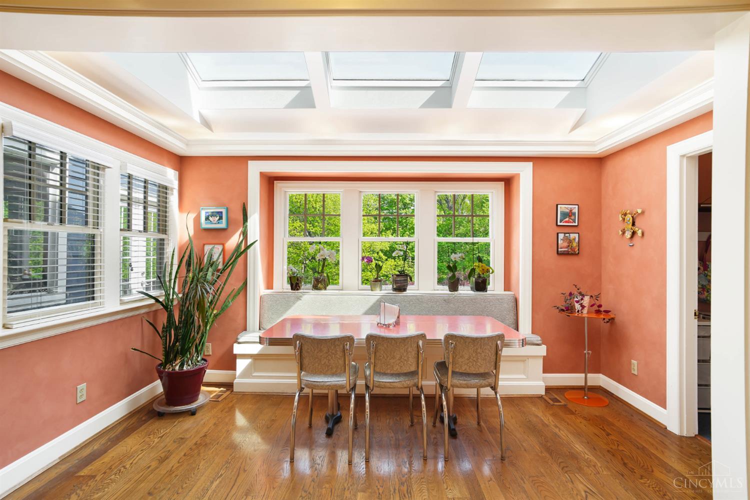 2780 Walsh Road Cincinnati, OH 45208 - Photo 13 of 68 The bright and inviting breakfast room is wrapped in windows and natural light, highlighted by a skylit ceiling and built-in banquette seating. Overlooking lush, tree-lined views, this cheerful space offers the perfect setting for casual dining while maintaining an effortless connection to the kitchen and main living areas.