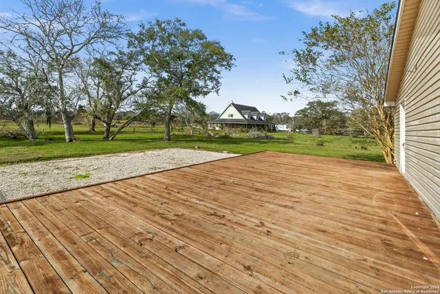 a view of empty space with wooden fence