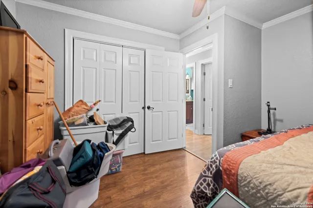 a bedroom with a bed and a chandelier