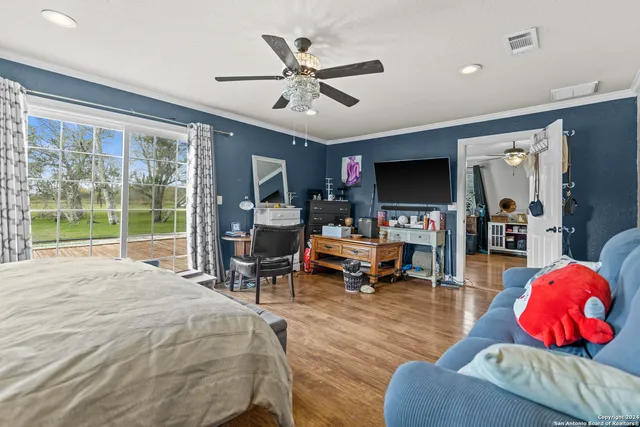 a bed room with furniture and a flat screen tv