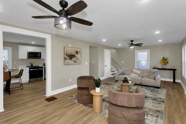 a living room with furniture and view of kitchen