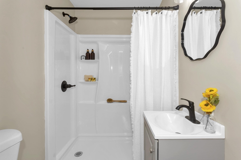 3 Norfolk Street Springfield, MA 01109 - Photo 13 of 42 a bathroom with a sink and a mirror