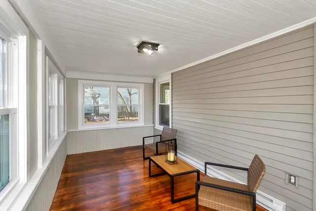 a view of a livingroom with lounge chair and a window
