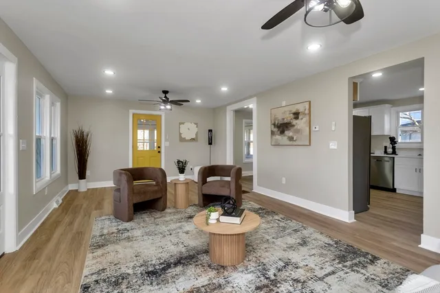 a living room with furniture and a chandelier