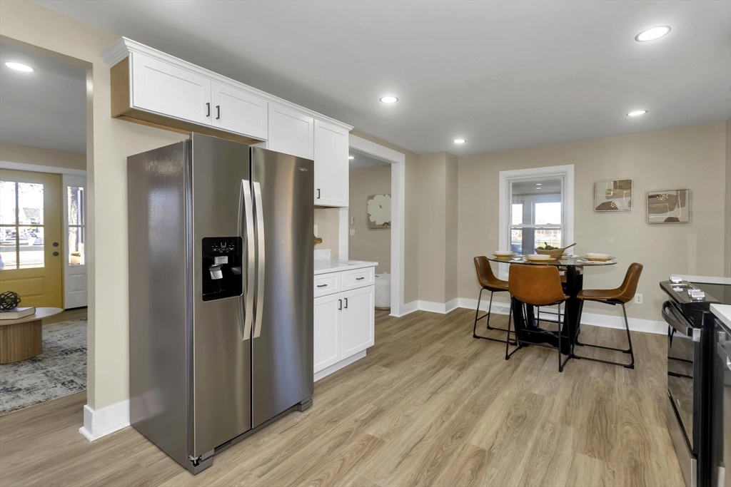 3 Norfolk Street Springfield, MA 01109 - Photo 19 of 42 a kitchen with stainless steel appliances a refrigerator a table and chairs