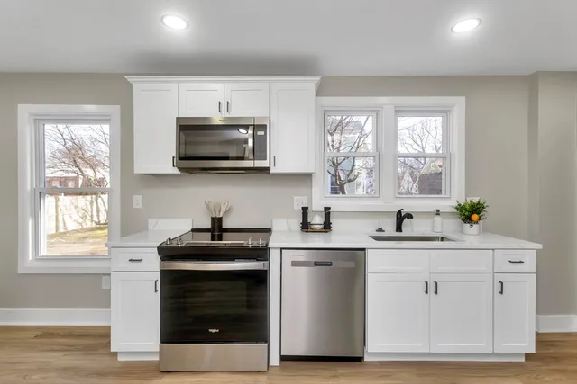 a kitchen with a sink stove and microwave