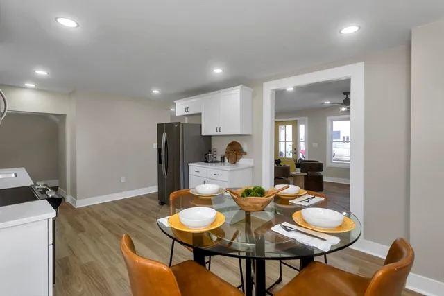 a dining room with furniture and wooden floor