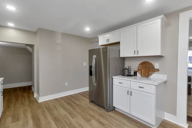 a kitchen with stainless steel appliances granite countertop a refrigerator and a stove top oven