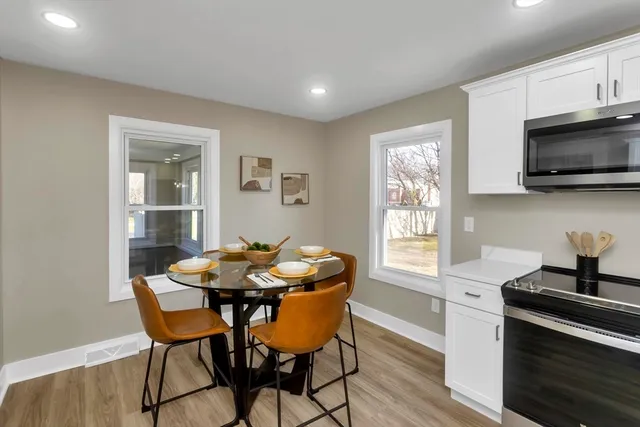 a dining room with furniture and window