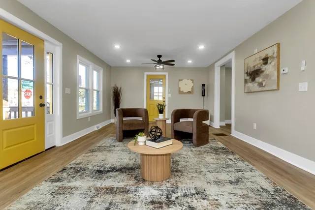 a living room with furniture a window and a dining table