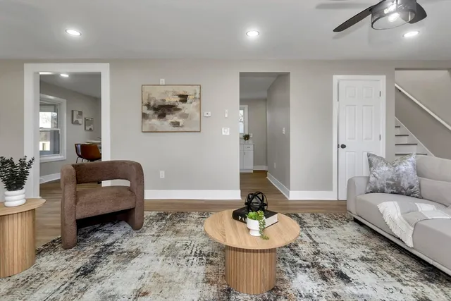 a living room with furniture and a wooden floor