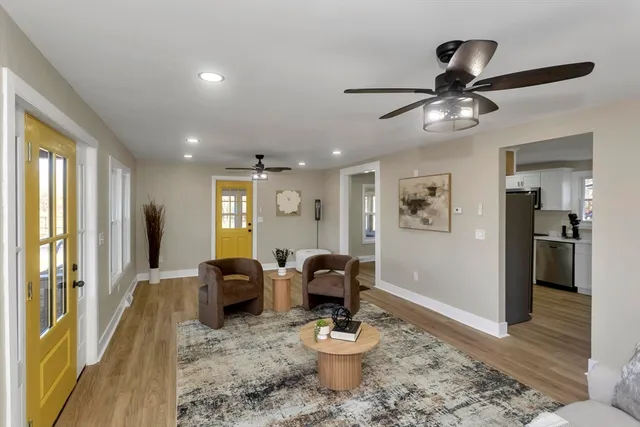 a living room with furniture and a wooden floor