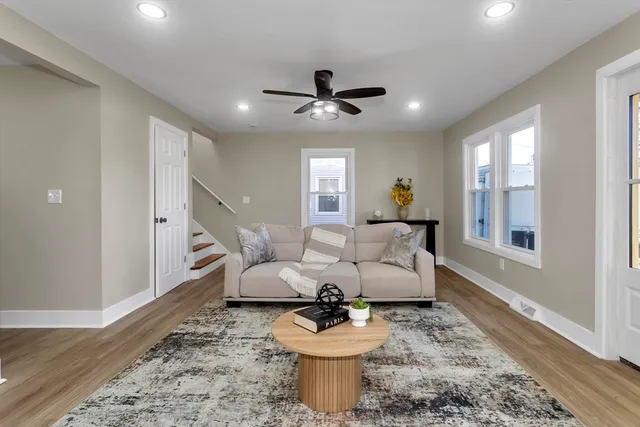 a living room with furniture and a chandelier