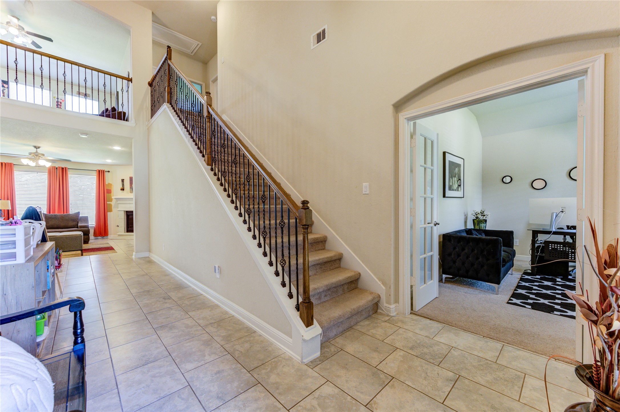 24511 Stratton Creek Drive Spring, TX 77373 - Photo 4 of 27 impressive foyer welcomes you with soaring ceilings and opens seamlessly to the spacious living area, while a private home office is conveniently located just off the entry.