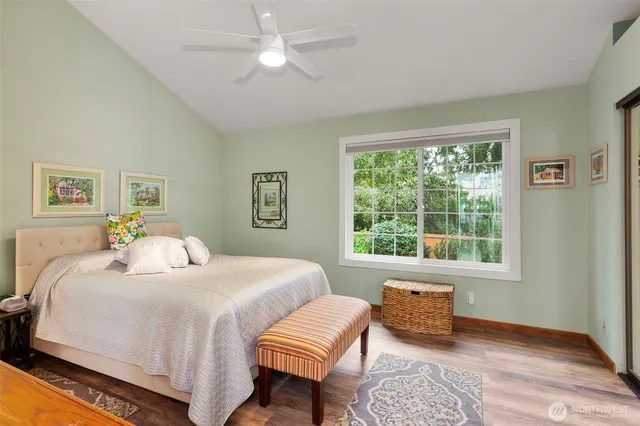 a bedroom with a bed a couch and a window