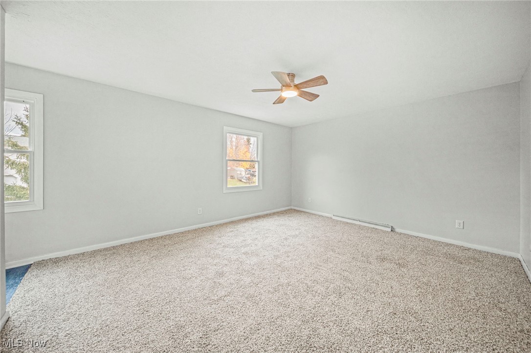 91 Paradise Road Painesville, OH 44077 - Photo 27 of 39 Carpeted spare room featuring baseboards and a baseboard radiator
