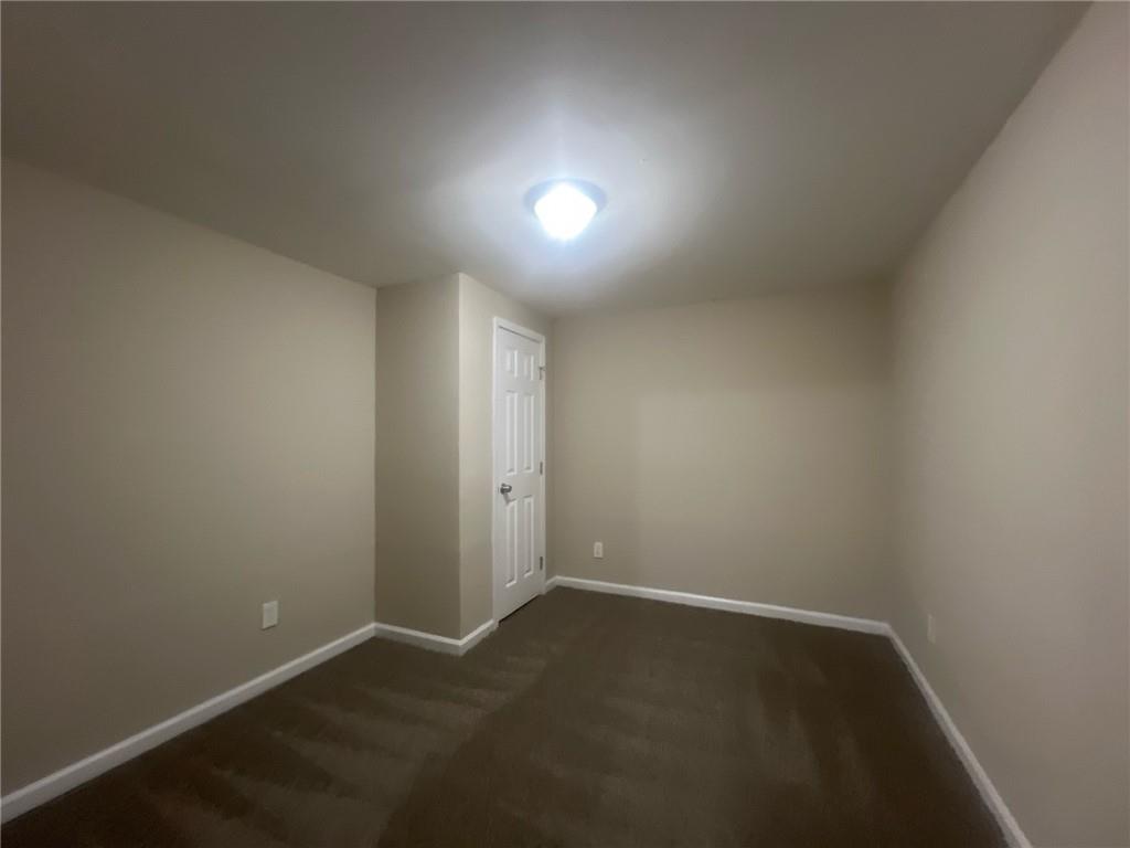2785 Battle Forrest Drive Decatur, GA 30034 - Photo 13 of 16 an empty room with wooden floor and windows
