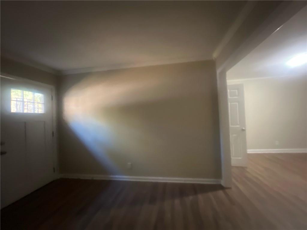2785 Battle Forrest Drive Decatur, GA 30034 - Photo 4 of 16 an empty room with wooden floor and windows with curtains